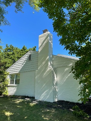 New white stucco on the chimney of a home.