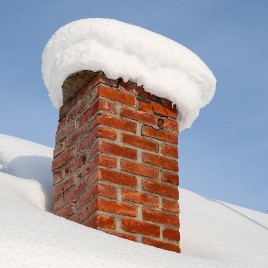 Chimney with several inches of snow.