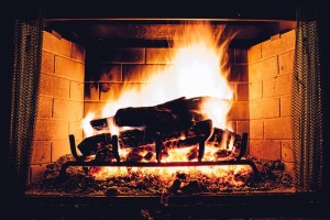 Fireplace in Media PA with an active fire warming a home.